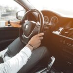 person with hands on the steering wheel